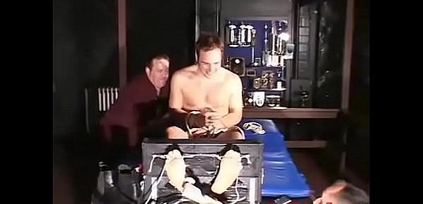  Two older guys having fun tickling a tied up younger dude